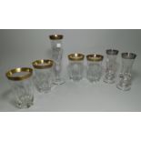 Four cut glass tumblers with gilt rims and three similar glasses