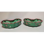A pair of Chinese kidney shaped canton enamel brush pots decorated with pink and blue flowers