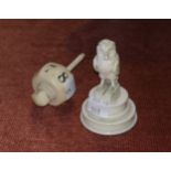 A 19th century ivory octagonal gaming spinner, 8cm; a Dieppe carved ivory figure of an owl, 7.5cm