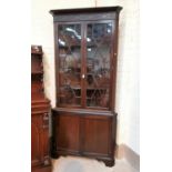 A 19th century mahogany full height corner cupboard, the upper section with moulded cornice, blind