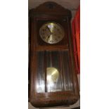A 1930s oak cased wall clock with strike