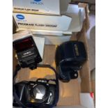 A Minolta SLR 7000; 2 boxed lenses; other camera equipment
