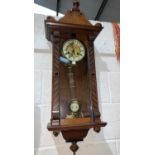 A walnut cased Vienna wall clock with spring driven striking movement