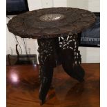 An Indian carved hardwood occasional table with circular top, on octagonal folding base, 53 cm