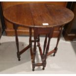 A mahogany drop leaf occasional table with circular top