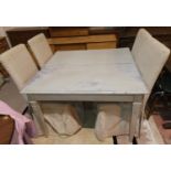 A rectangular dining table in a "Shabby Chic" classical stlye, extending to 81" with 2 spare leaves,