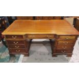 A large reproduction partner desk in stained mahogany, with 6 frieze and 6 pedestal drawers