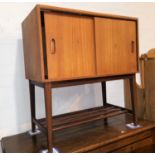 A 1960's teak record cabinet with sliding doors