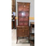 An Edwardian mahogany full height display cabinet with single astragal glazed door over double doors