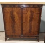 A Georgian style figured mahogany side cabinet with cluster pillars and 2 oval panel doors, on
