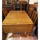 A period style golden oak dining suite comprising rectangular drop leaf table and 4 'Country