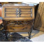 A 1920's oak bureau of Jacobean style, barley twist stretchers, fitted interior, 74 cm