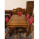 A 1930's golden oak dining suite comprising large draw leaf table, 4 chairs and sideboard of 2