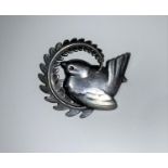 A Georg Jensen silver brooch depicting a wren sitting within a curved fern branch, 5 cm, model no