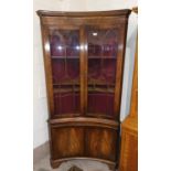A Georgian style full height corner display cabinet in the manner of Bevell Funnell, free standing