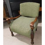 A 1930's oak low seat nursing chair in green moquette