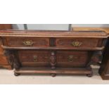 A 19th century side table with extensive carving, 2 drawers and lion mask columns