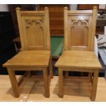 A pair of oak chair with gothic carved panel backs