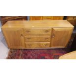 An Ercol elm low sideboard of 2 cupboards and 3 drawers