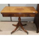 A figured mahogany fold-over card table in the Georgian style, on turned column with quatrefoil