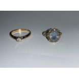 A 9 carat hallmarked gold diamond solitaire ring; a 9 carat hallmarked gold dress ring with a blue