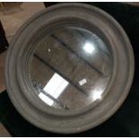 A circular wall mirror in heavy grey stained wooden frame; a pine framed rectangular mirror