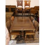 A 1930's oak dining suite comprising draw leaf on bulbous legs, 6 studded leather dining chairs, and