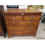 An early 19th century crossbanded golden oak chest of 3 long and 2 short drawers with brass swan