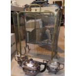 A silver plated 3 piece tea service; a mirrored firescreen; a brass fireguard