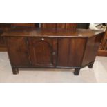 An 18th century oak country made low side cabinet with single door and canted end