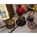 A reproduction brass oil lamp; a selection of pewter; cast iron and copper pans; etc.