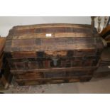 A 19th century wood and metal bound chest with dome top and hide decoration