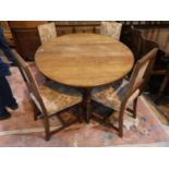 A period style distressed oak dining suite by Titchmarsh & Goodwin comprising oval dropleaf table