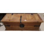 A rustic pine chest with metal bindings