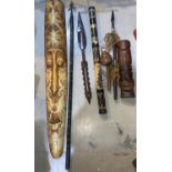 A selection of African carvings/masks; weapons; instruments; etc.