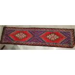 A mid 20th century Tunisian hand knotted runner, Persian design on red ground