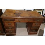 An Edwardian walnut kneehole desk on twin pedestal with 3 frieze and 6 pedestal drawers