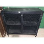 A black metal side cabinet enclosed by 2 mesh doors