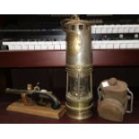 An early 20th C brass miner's lamp with steel bonnet 'Woods Improved Lamp', a vintage signal /