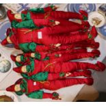 Seven large and 3 small jester dolls in red and green costume