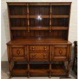 A 1930's golden oak Welsh dresser with raised delft rack and fitted base