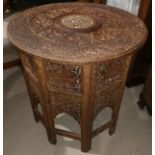 A carved hardwood occasional table; a folding mirror firescreen; a brass fire front trivet; a mantel