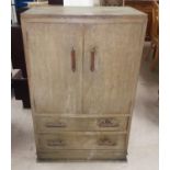 A limed oak tallboy linen cupboard