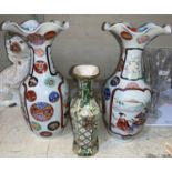 A pair of Japanese ceramic vases with flared rims, hand painted with panels depicting Samurai &