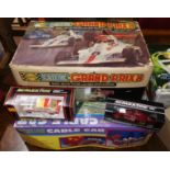 A Scalextric Grand Prix 8 set, boxed; 2 other cars; another boxed car game
