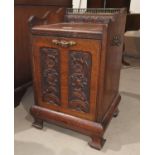 An Edwardian carved walnut coal box with fall front