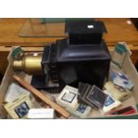 An early 20th century magic lantern projector and 8 sets of lantern slides