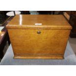 An Edwardian golden oak writing box, with foldout fall front and fitted interior