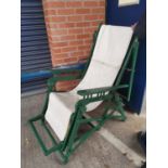 A late 19th/early 20th century patented folding sunchair with cover, green painted