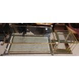 A brass and plate glass coffee table with corner column supports, 125 cm; a nest of similar tables